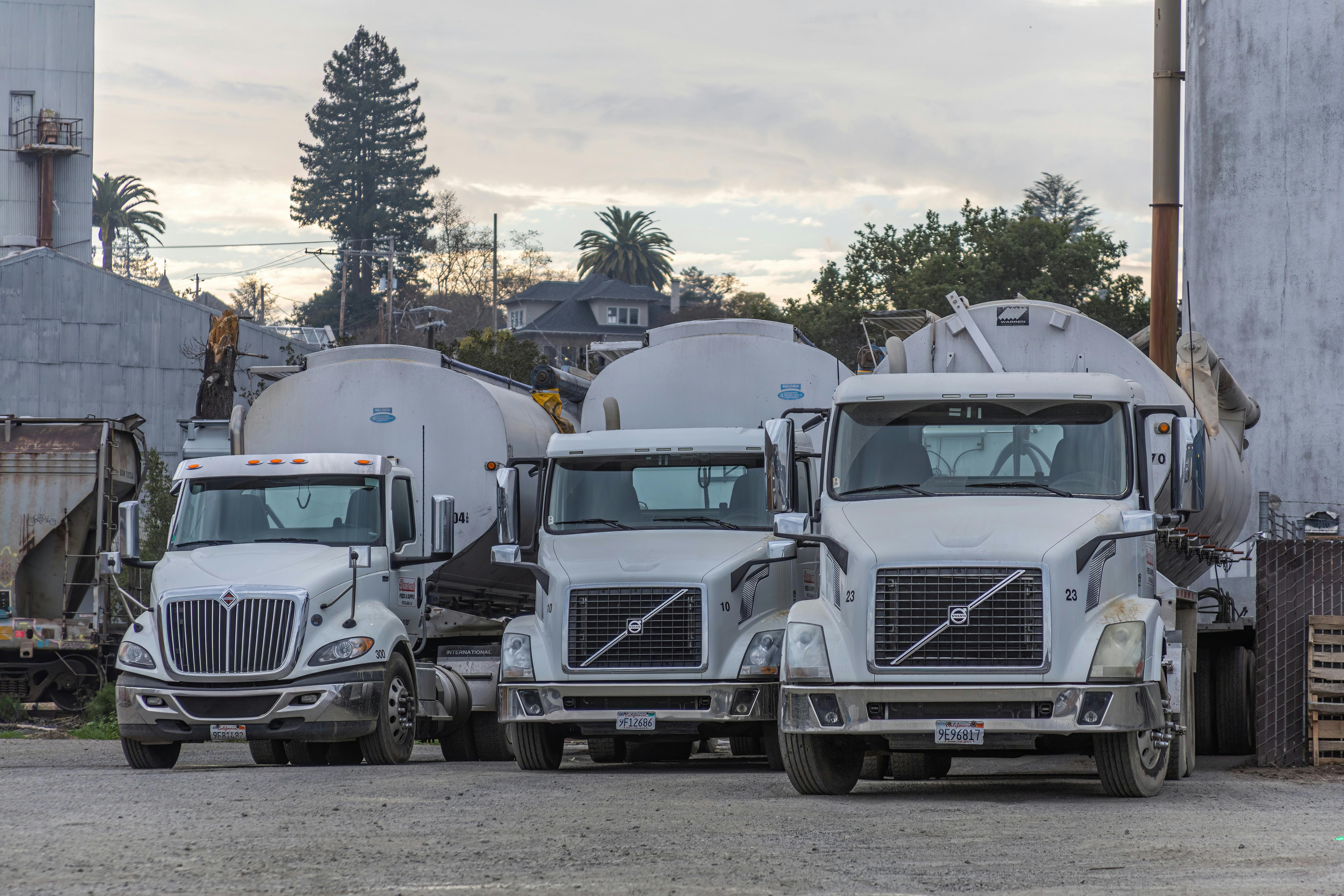 Heavy-duty trucks parked in an industrial yard
